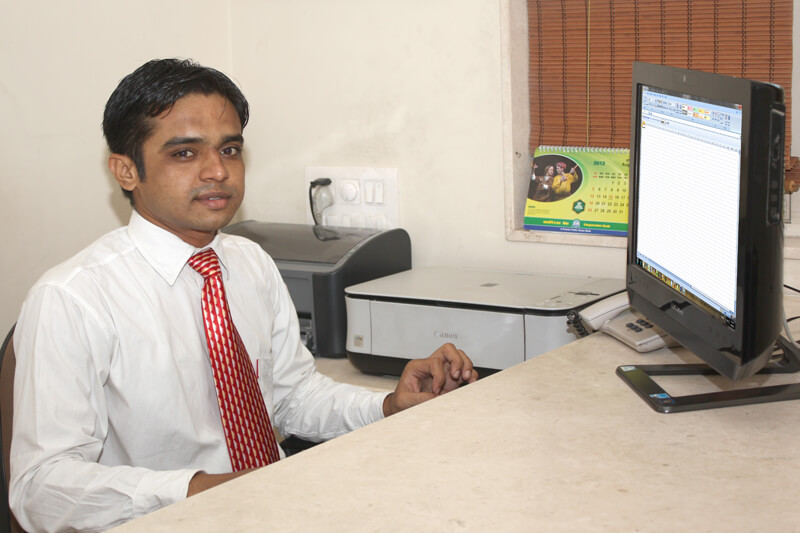 Photograph of an executive working on computer in Rajkot