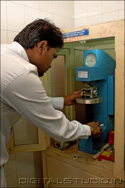 Worker in a factory testing equipment