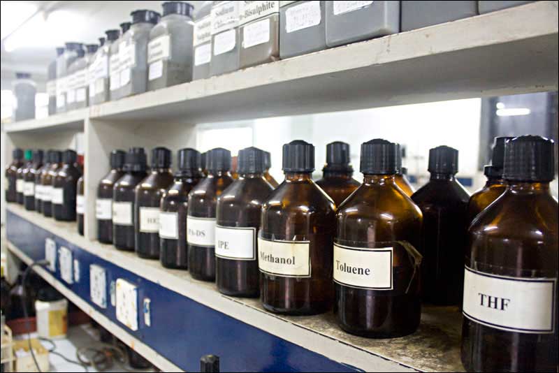 Rows of chemical bottles in a lab