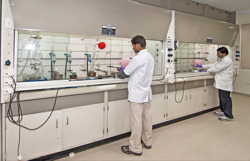 Wide angle photograph of lab with workers