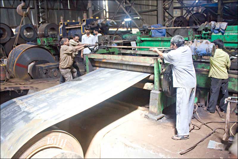 workers working on a steel sheet rolling company
