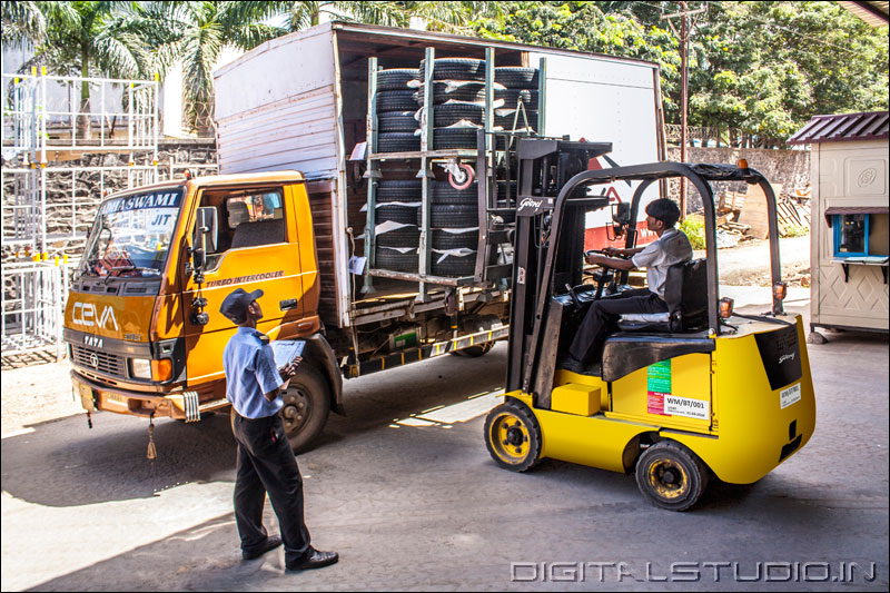 Forklift operator removing goods from a truck