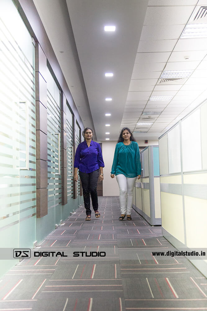 two lady office staff walking in office