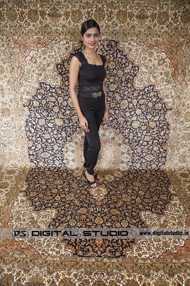 Model wearing black dress on Kashmir silk Carpet