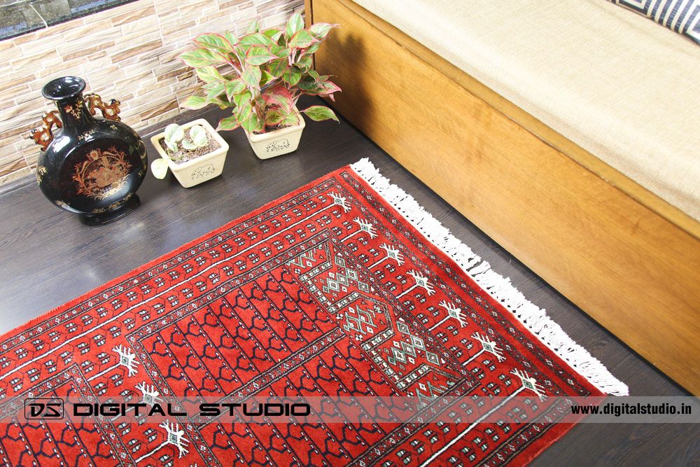 Red oriental carpet on wood flooring