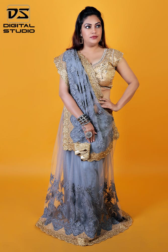 Indian bride wearing sari on orange background