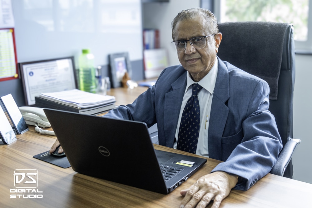 Senior executive posing on his desk