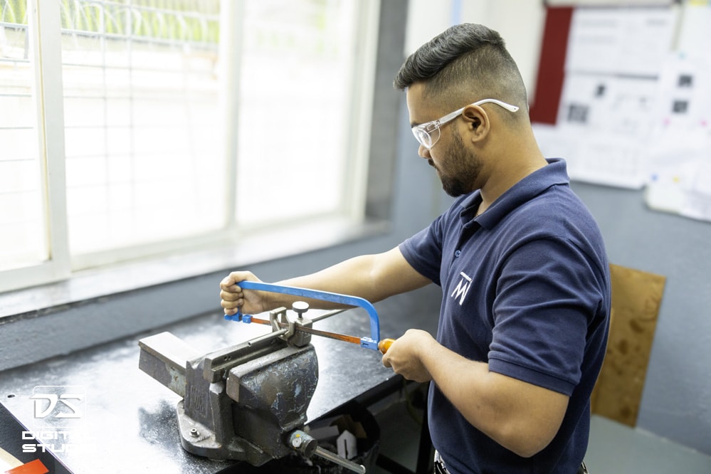 Technician working with the hacksaw