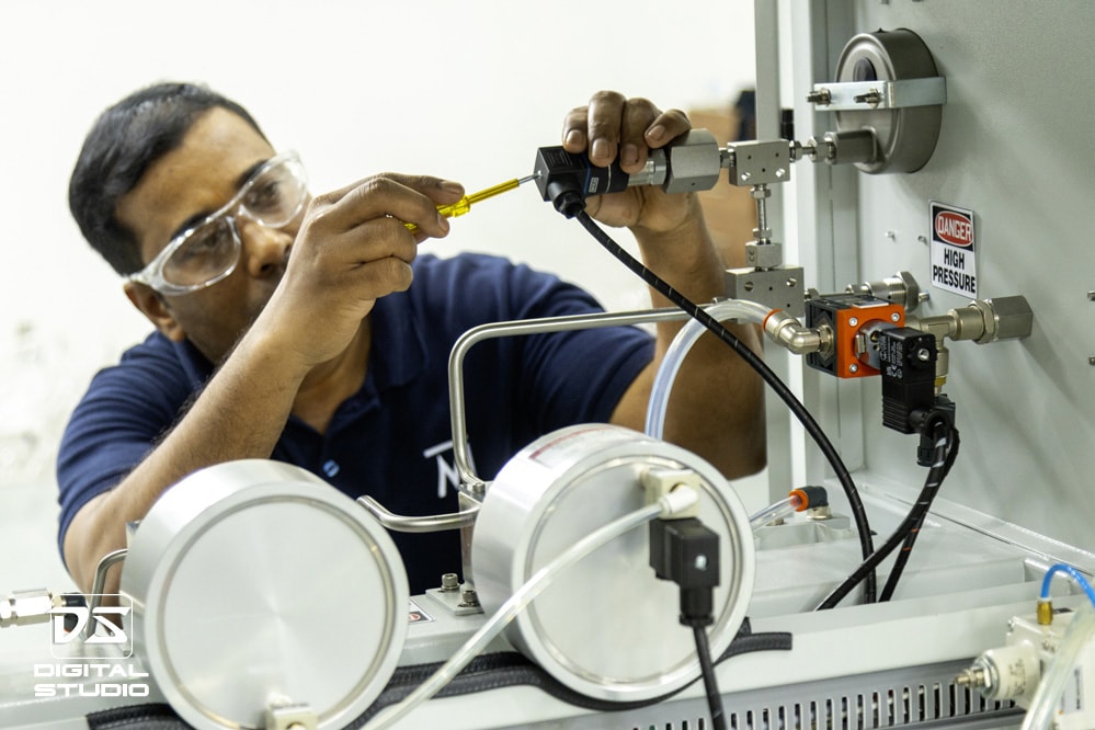 Technician fixing a machine assembly