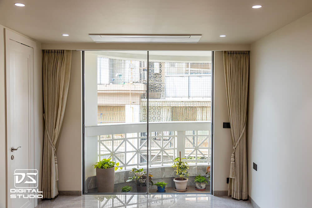 Guest bedroom with large windows and city view